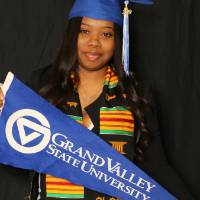 woman holding up gvsu flag at GradFest